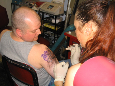 Mid-tattoo.